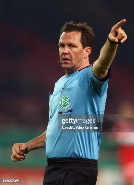 Referee Peter Sippel gestures during the second round match of the DFB Cup between VfB Stuttgart and FC St.Pauli at Mercedes-Benz Arena on October...