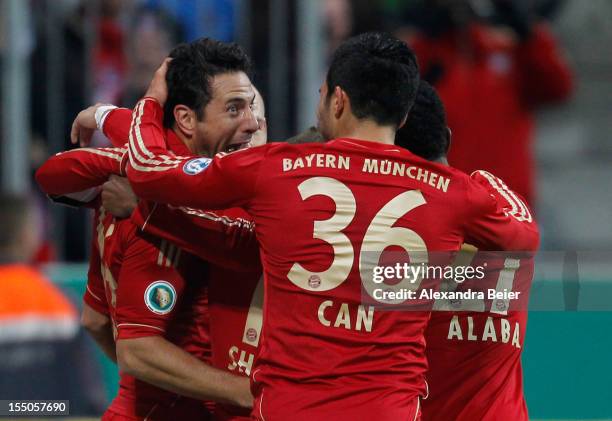 Claudio Pizarro of Bayern Muenchen celebrates his team's first goal together with his teammates Emre Can and David Alaba during the DFB Cup second...