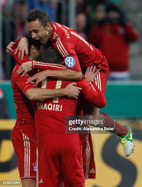 Claudio Pizarro of Bayern Muenchen celebrates his team's first goal together with his teammates Xherdan Shaqiri and Rafinha during the DFB Cup second...