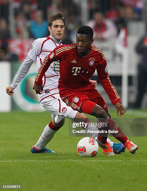 David Alaba of Bayern Muenchen fights for the ball with Konstantinos Fortounis of Kaiserslautern during the DFB Cup second round match between FC...