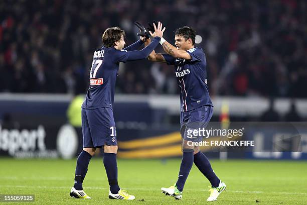 Paris Saint-Germain's Brazilian defender Thiago Silva is congratulated by team mate Brazilian defender Maxwell after scoring a goal during a French...