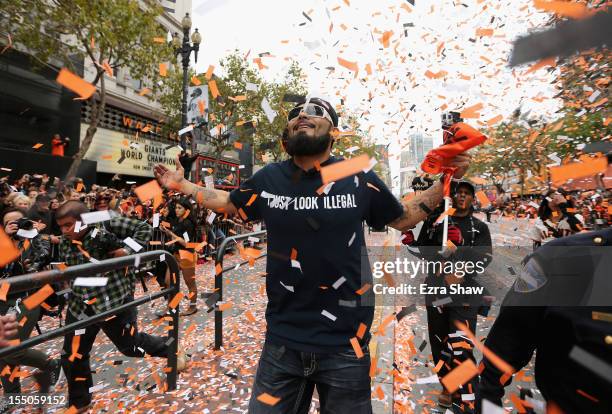 Pitcher Sergio Romo of the San Francisco Giants runs along the parade route during the San Francisco Giants World Series victory parade on October...