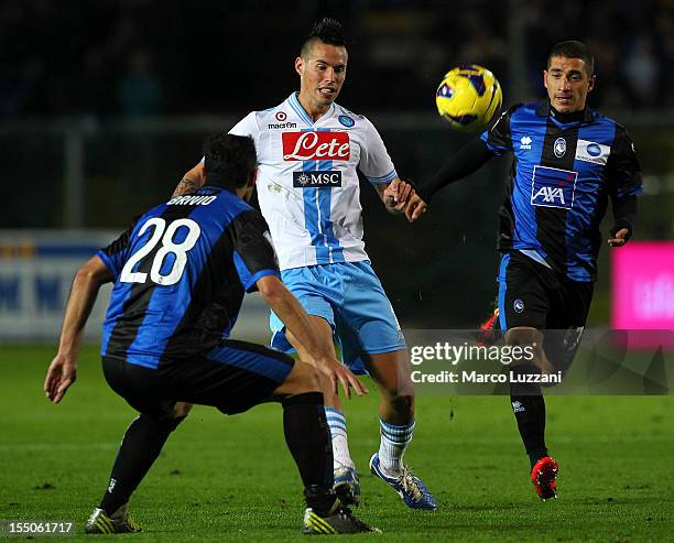 Marek Hamsik of SSC Napoli competes for the ball with Davide Brivio and Carlos Carmona of Atalanta BC during the Serie A match between Atalanta BC...