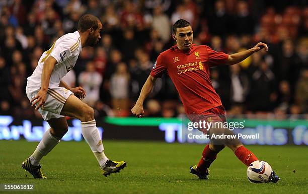 Ashley Richards of Swansea and Oussama Assaidi of Liverpool compete during the Capital One Cup Fourth Round match between Liverpool and Swansea City...