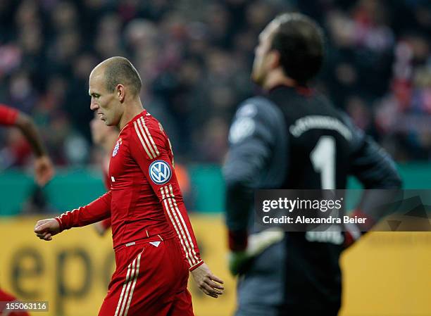 Arjen Robben of Bayern Muenchen walks past goalkeeper Tobias Sippel of Kaiserslautern after he scored his first goal during the DFB Cup second round...