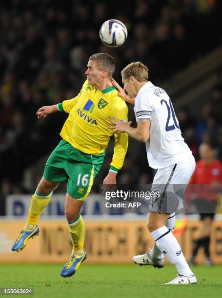 Norwich City's English-born Welsh striker Steve Morison vies with Tottenham Hotspur's English defender Michael Dawson during the English League Cup...