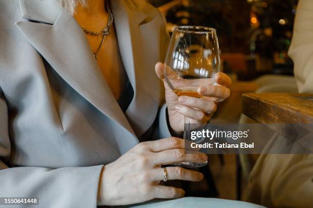 woman holding glass of wine in restaurant - istra istrinsky district stock pictures, royalty-free photos & images