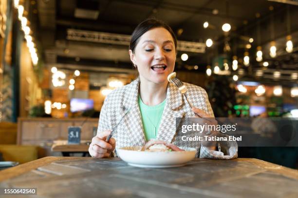 happy woman tasting food in restaurant - istra istrinsky district stock pictures, royalty-free photos & images