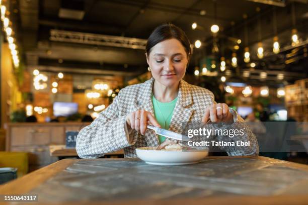 happy woman enjoying food in restaurant - istra istrinsky district stock pictures, royalty-free photos & images