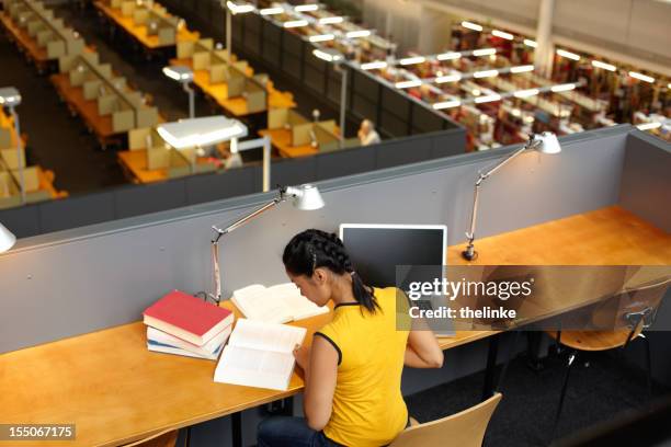 female student in the academic library - student behind laptop stock pictures, royalty-free photos & images