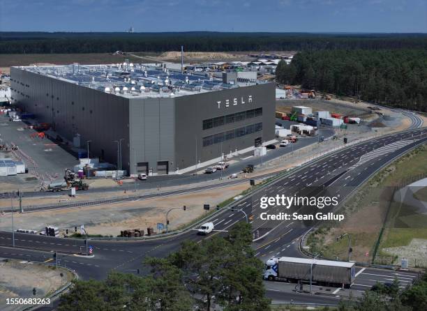 In this aerial view the Tesla logo hangs on the facade of a building at the Tesla factory on July 17, 2023 near Gruenheide, Germany. Tesla will...