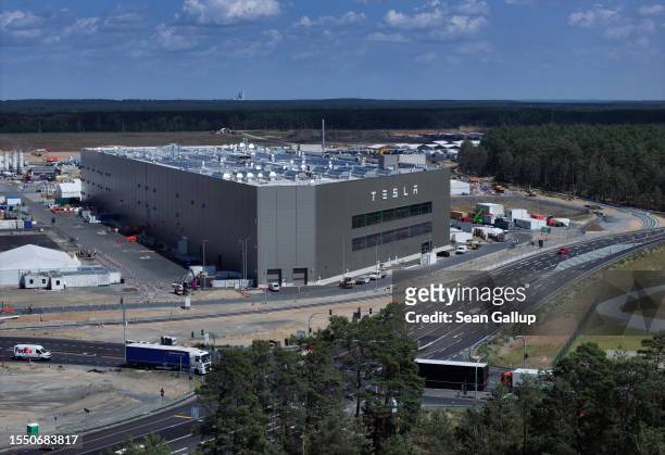 In this aerial view the Tesla logo hangs on the facade of a building at the Tesla factory on July 17, 2023 near Gruenheide, Germany. Tesla will...
