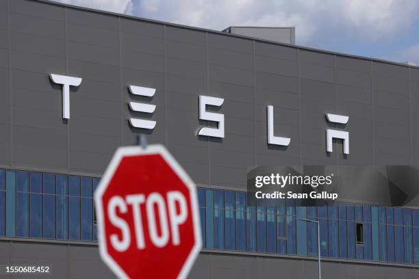 Stop sign stands near the Tesla logo at the Tesla factory on July 17, 2023 near Gruenheide, Germany. Tesla will reportedly present its plans tomorrow...