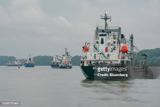 Multiple bulk carrier cargo ships navigate the Sulina Canal, a river channel between the Danube River and the Black Sea, in Tulcea, Romania, on...