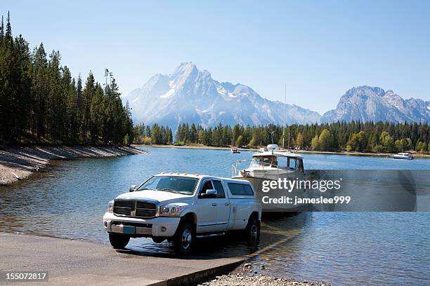 launching at boat ramp - boat in lake stock pictures, royalty-free photos & images