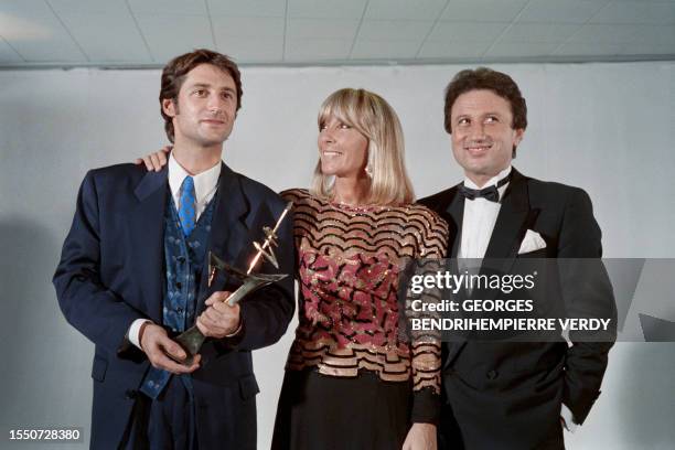 French Tv host Antoine de Caunes , awarded with the 7 d'Or for the best TV host, poses with TV host Michel Drucker and his wife Dany Saval, on...