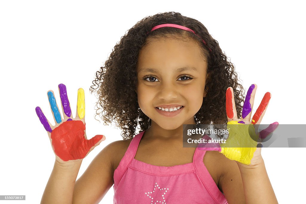 Little African American girl playing with finger paint