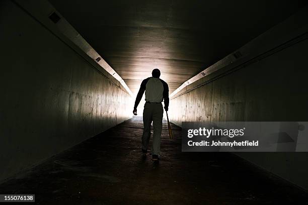 baseball player walking with bat - baseball bats stock pictures, royalty-free photos & images