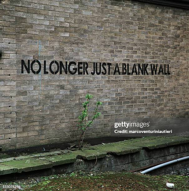 no longer just a blank wall - urban graffiti, english - stencil font stock pictures, royalty-free photos & images