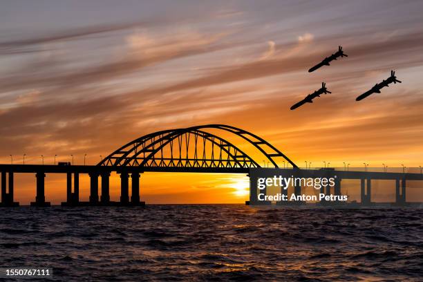 cruise missiles over the bridge at sunset. crimea, ukraine - crimea foto e immagini stock