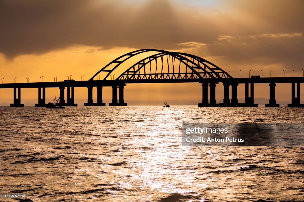 Bridge in the sea at sunset. Crimea, Ukraine