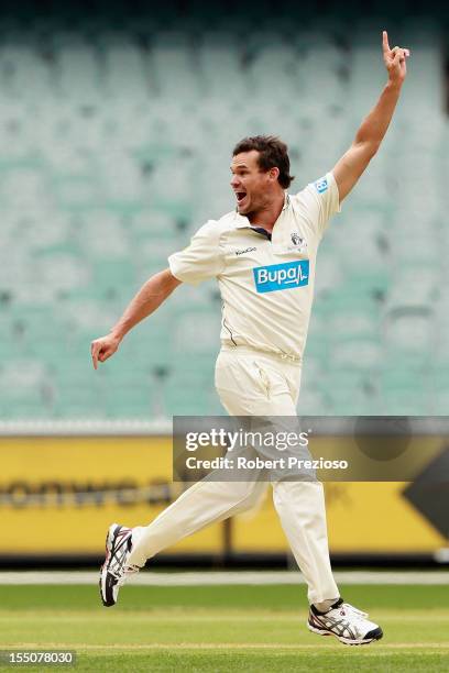 Clint McKay of the Bushrangers celebrates the wicket of Marcus Harris of the Warriors during day one of the Sheffield Shield match between the...