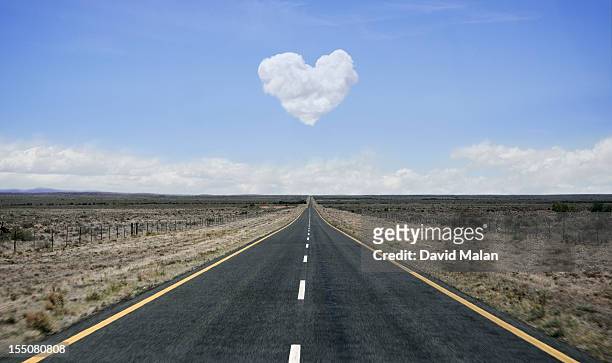 remote road with heart shaped cloud over it. - front view bildbanksfoton och bilder