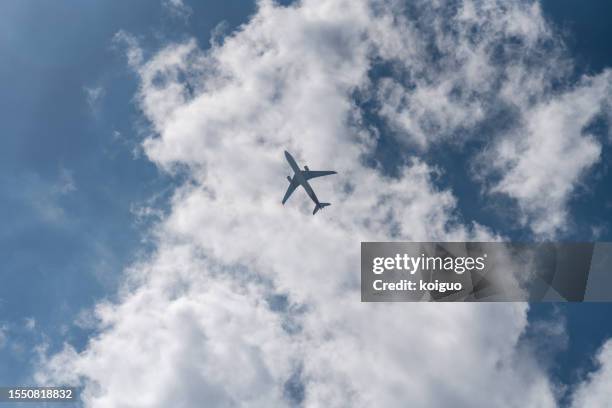 the passenger plane passed through the clouds - air jet stock pictures, royalty-free photos & images