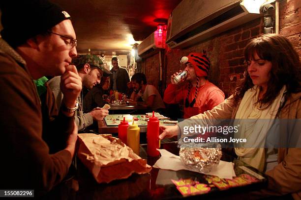 People play monopoly in an East Village restaurant October 31, 2012 in New York City. Superstorm Sandy has claimed several dozen lives in the United...