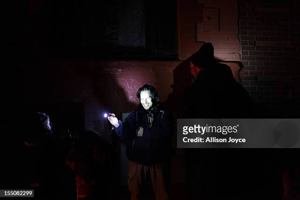 East Village residents play with a flashlight October 31, 2012 in New York City. Superstorm Sandy has claimed several dozen lives in the United...