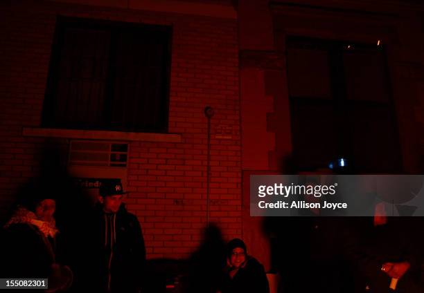 East Village residents enjoy a bonfire October 31, 2012 in New York City. Superstorm Sandy has claimed several dozen lives in the United States and...