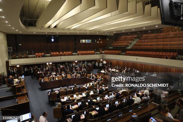 Parliamentarians attend a session at the Knesset, Israel's parliament, in Jerusalem on July 24 amid a months-long wave of protests against the...