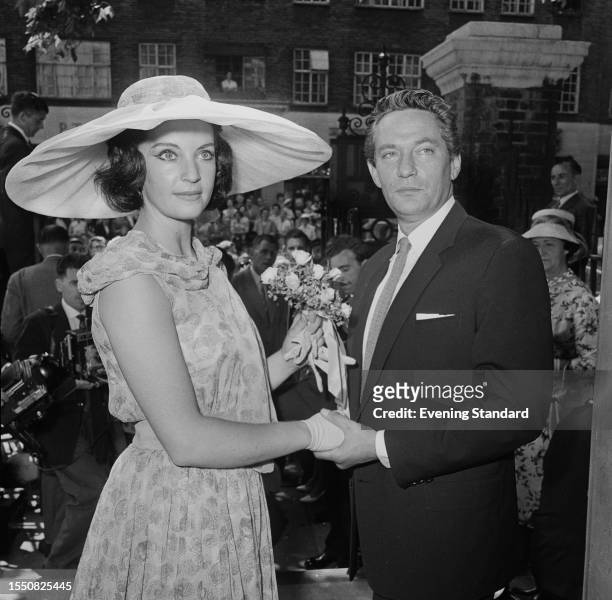 British actors Yolande Turner and Peter Finch pose outside Chelsea Register Office following their marriage ceremony, King's Road, London, July 4th...