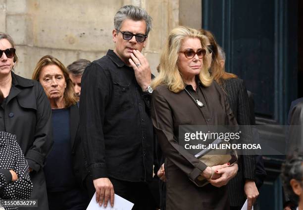 French singer Benjamin Biolay and French actress Catherine Deneuve react at the end of the funeral ceremony for late British-French singer and...