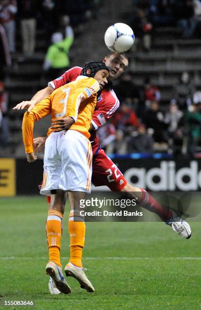 Calen Carr of Houston Dynamo and Austin Berry of Chicago Fire head the ball in an MLS match on October 31, 2012 at Toyota Park in Bridgeview,...