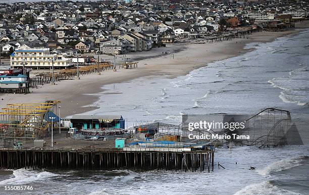 Waves break in front of a destroyed amusement park wrecked by Superstorm Sandy on October 31, 2012 in Seaside Heights, New Jersey. At least 50 people...