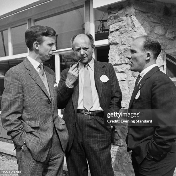 British racing driver Tony Brooks and Stirling Moss with racing impresario Raymond Mays , April 8th 1959.