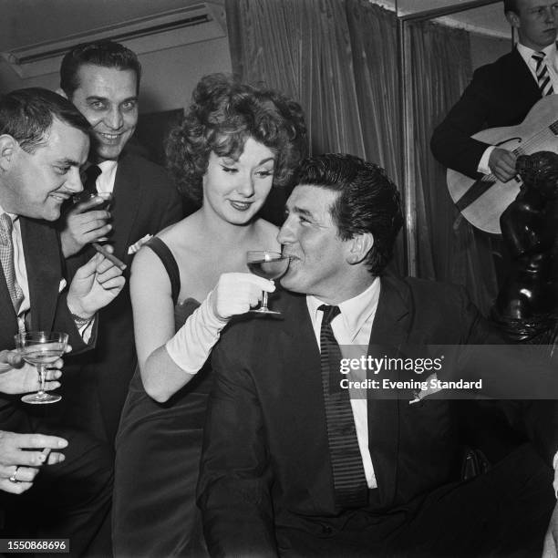 British actress Barbara Roscoe shares her drink with Irish stuntman Tommy Yeardye , former boyfriend of actress Diana Dors, April 20th 1959.