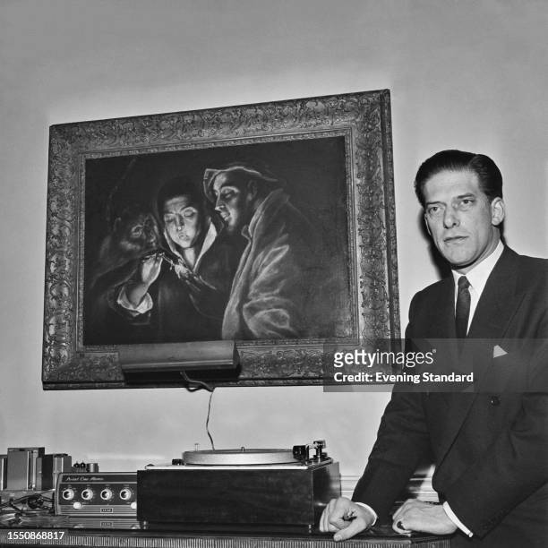 George Lascelles, 7th Earl of Harewood , poses with the painting 'Fable' by El Greco at Harewood House in Yorkshire, April 16th 1959. The painting's...