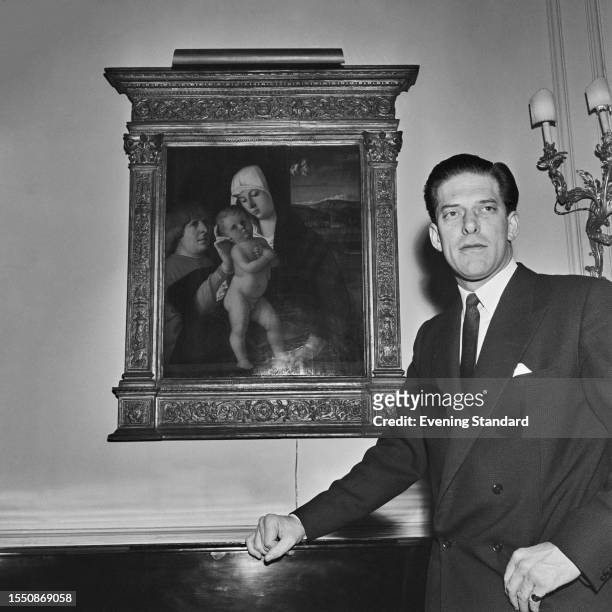 George Lascelles, 7th Earl of Harewood , poses with the painting 'Madonna and Child with a Donor', attributed to Giovanni Bellini, at Harewood House...