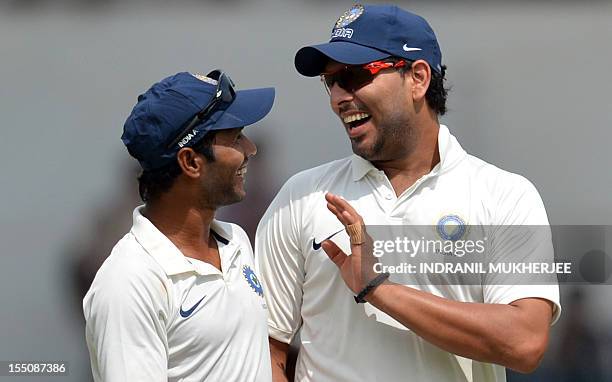 India 'A' cricketers Ashok Dinda and Yuvraj Singh share a light moment as they walk back after the end of the England innings on the final day of a...