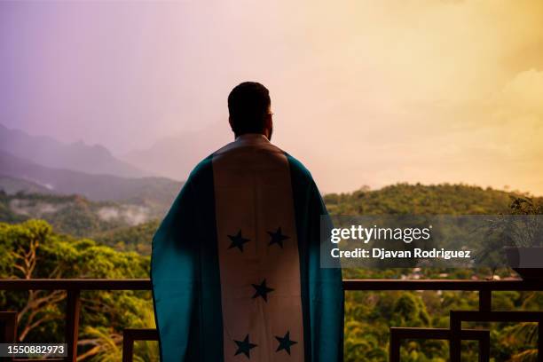 a person with honduras flag in front a mountain in a sunset. - honduras mountains stock pictures, royalty-free photos & images