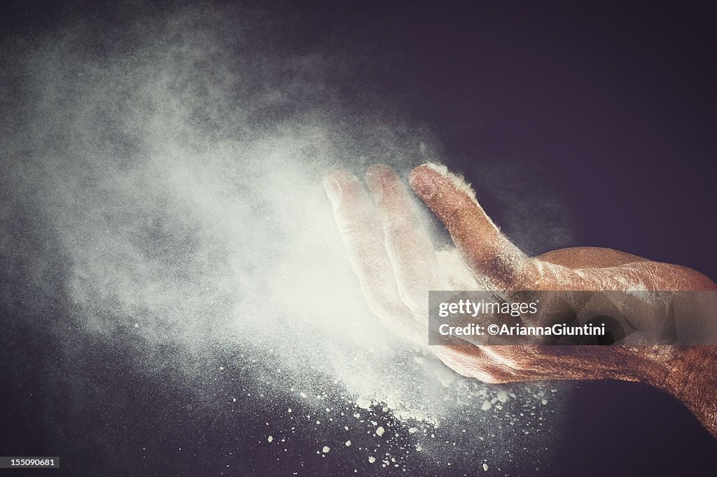 Flour blew from the hand