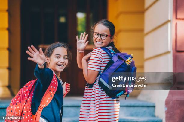 schoolgirls smiling to camera - route 13 stock pictures, royalty-free photos & images