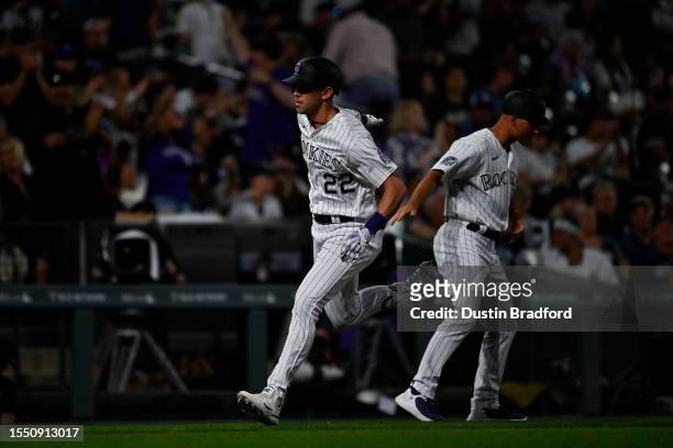 Nolan Jones of the Colorado Rockies is congratulated by third base coach Warren Schaeffer after hitting an eighth inning solo home run in a game...
