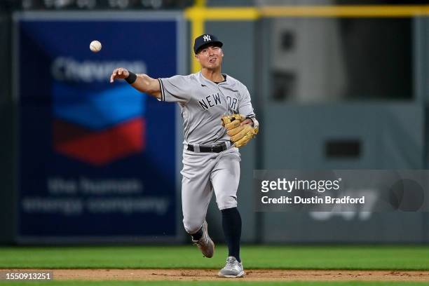 Anthony Volpe of the New York Yankees throws to first base after fielding a ground ball in the eighth inning of a game against the Colorado Rockies...