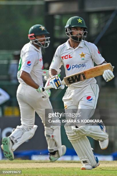 Pakistan's Abdullah Shafique and Shan Masood run between wickets during the first day of the second and final cricket Test match between Pakistan and...