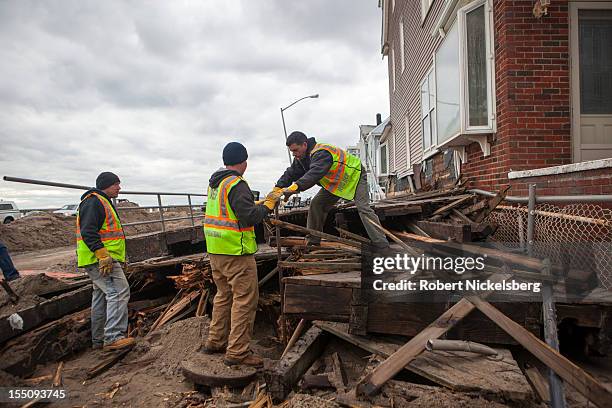 Work crew from the New York Department of Environmental Protection turns off a water valve in Rockaway Beach after Superstorm Sandy hit during the...