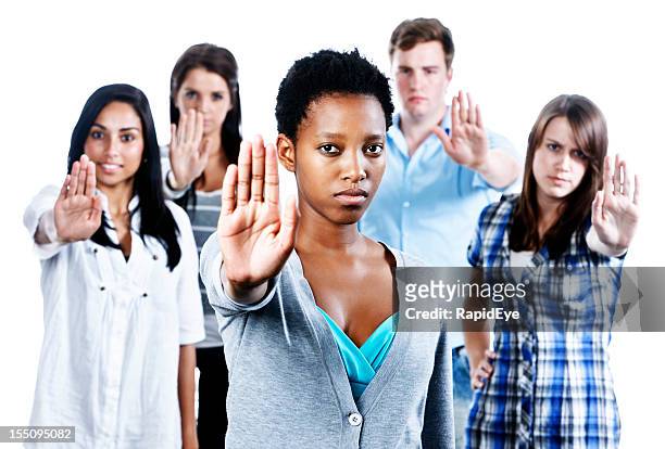 five serious young people indicate &quot;stop&quot;  holding up their hands - temptation stock pictures, royalty-free photos & images