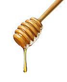 Organic Honey with wooden dipper against white